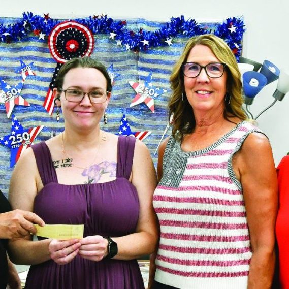 Class of 1976 representatives present Pierce Senior Center Director Fancy Moore with a check. Left to right: 1976 class member Roberta (Warneke) Watts, Moore, 1976 class member Sue (Manzer) Bachman, and 1976 class member Rhonda (Reed) Peters. 