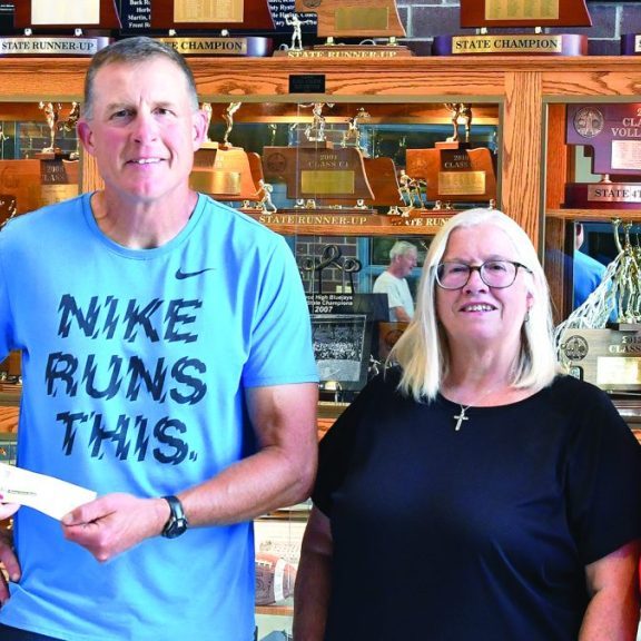 Class of 1976 representatives present Pierce High School Teammates Representative Mark Brahmer with a check that will be used for the Teammates Scholarship Fund. Left to right: 1976 class member Sue (Manzer) Bachman, Brahmer, 1976 class member Roberta (Warneke) Watts, and 1976 class member Rhonda (Reed) Peters.