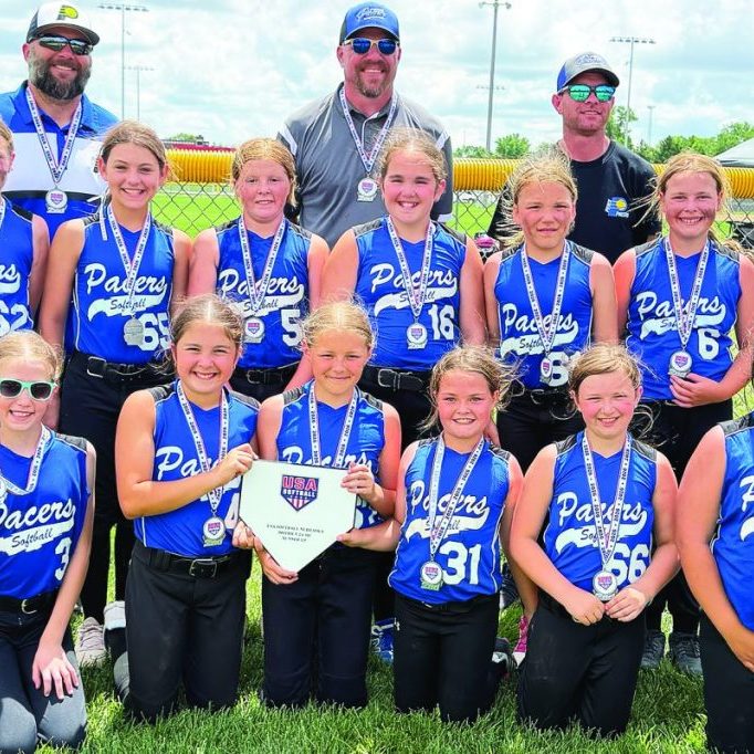 Pierce Blue 10U, front row, left to right: Tinley Hammer, Adah Hervert, Beckett Krueger, Sawyer Hamilton, Kenzie Oelrich, Taylor Lambrecht, CeCe Wragge. Middle row: Peyton Suckstorf, Harper Spiering, Josie Wachter, Berklee Krueger, Elise Ekberg, Kinley Bennett, Madelyn Wragge. Back row, coaches: Tyler Krueger, Brett Suckstorf, Nate Baumann. 